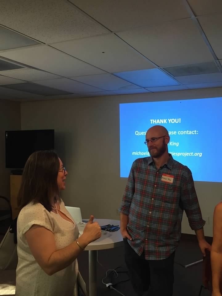 Michael King speaking with a woman at a training. 