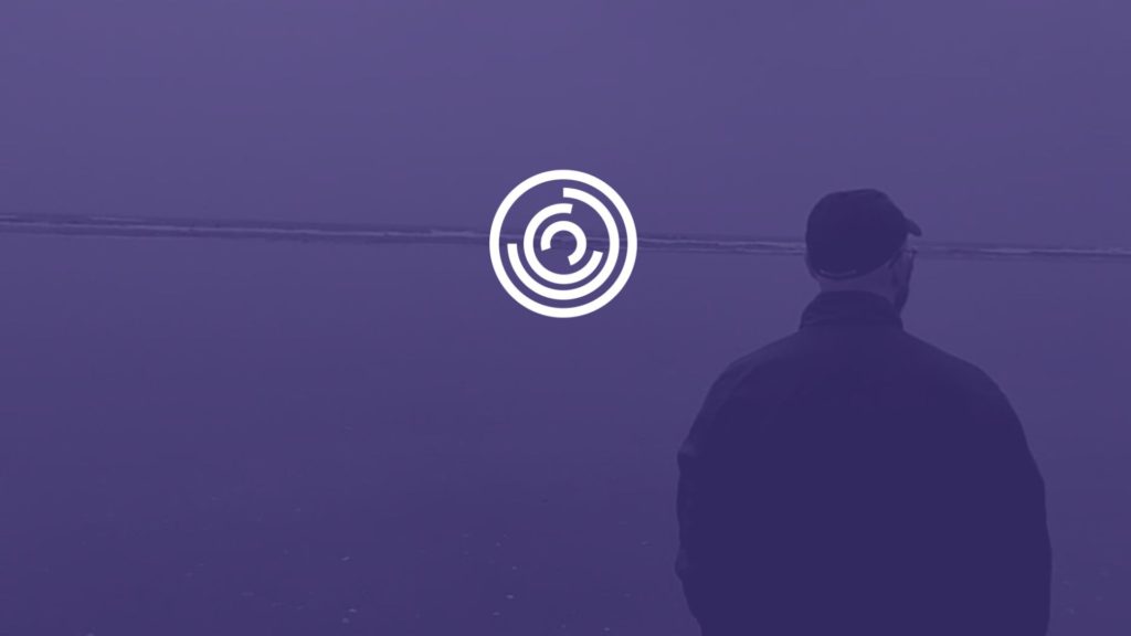 Header - Michael King In coat walking towards water