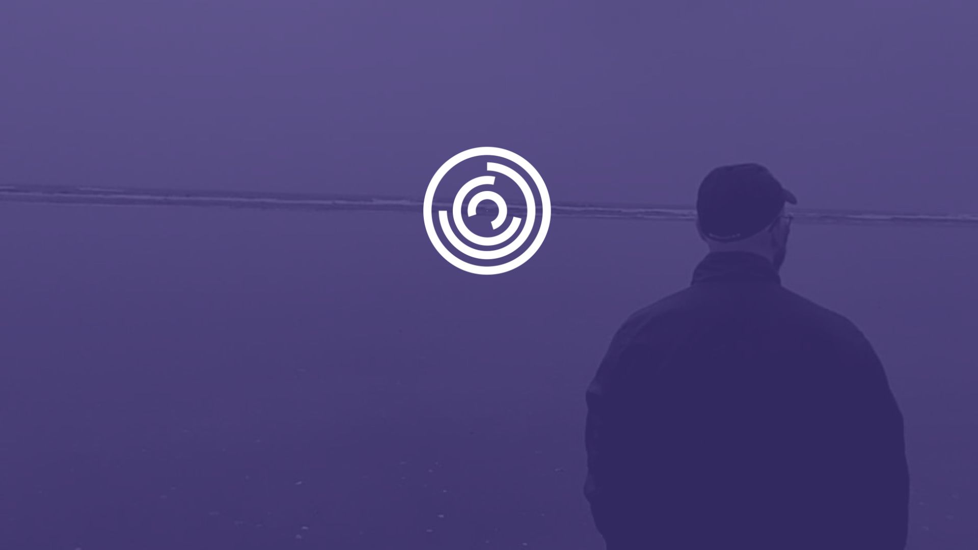 Header - Michael King In coat walking towards water