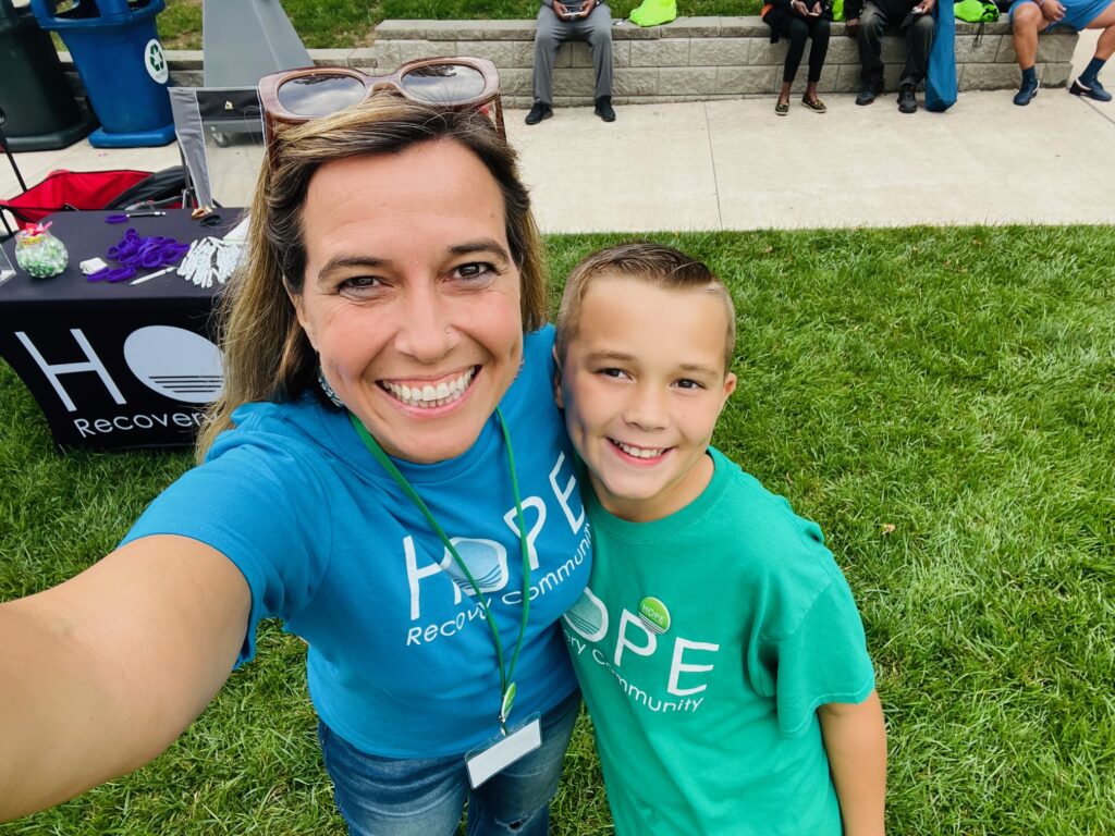 Stephanie Robinson and son on a grass field